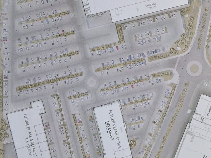 A detailed site plan showing the layout of the retail development, including existing store footprints, parking areas, and future expansion phases.
