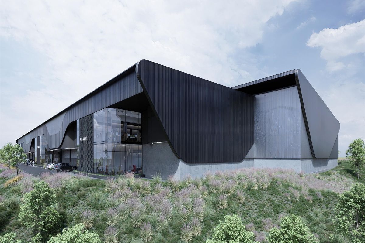Modern industrial facility featuring sleek black metal cladding, expansive glass curtain walls, and a professional concrete foundation design.