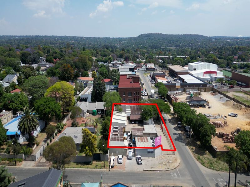 Aerial view of an industrial property site with multiple structures, highlighting the building footprint and surrounding urban landscape.