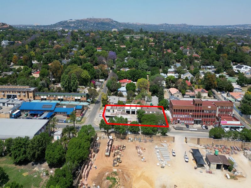 Aerial view of an industrial property site located within a mixed-use urban area, highlighting the building footprint and surrounding infrastructure.