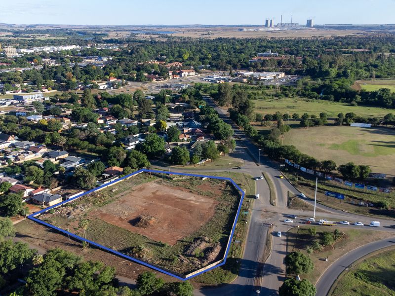Aerial view of a vacant commercial development site located at a prominent street intersection, offering significant potential for new retail construction.