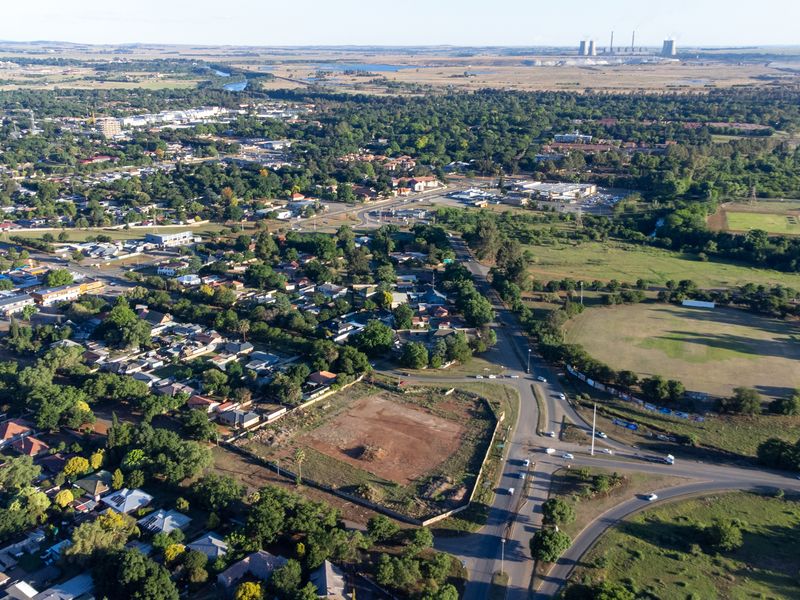 Aerial view of the surrounding neighborhood and local infrastructure, highlighting the property's location and proximity to main roads and green spaces.