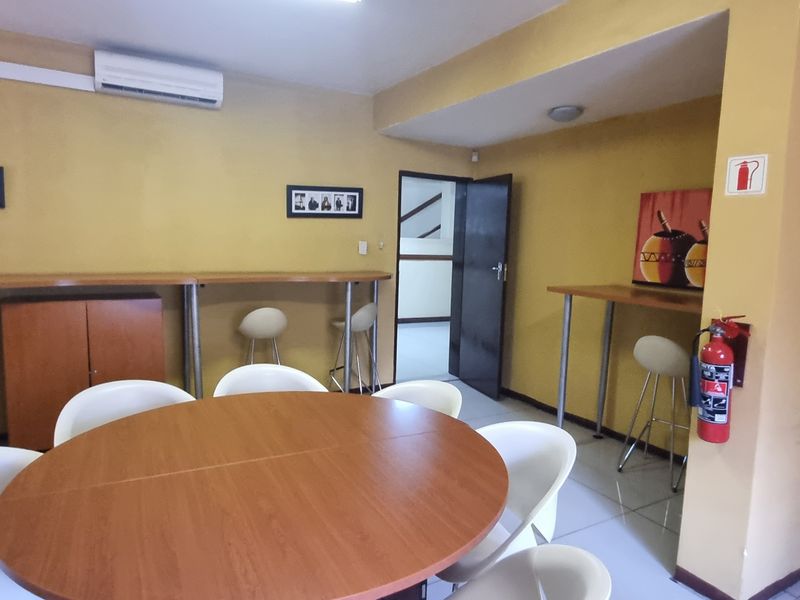 Office space featuring tiled flooring, a built-in counter, and a wall-mounted air conditioning unit.
