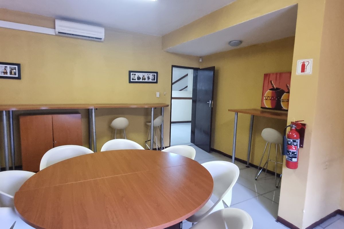 Office space featuring tiled flooring, a built-in counter, and a wall-mounted air conditioning unit.