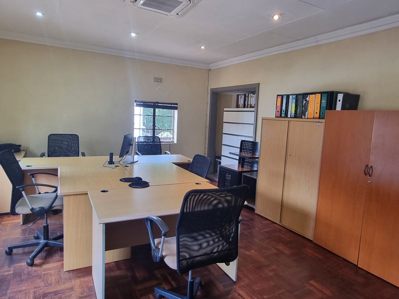 A functional office space featuring parquet flooring, recessed downlighting, and coving, providing a practical environment for professional work.