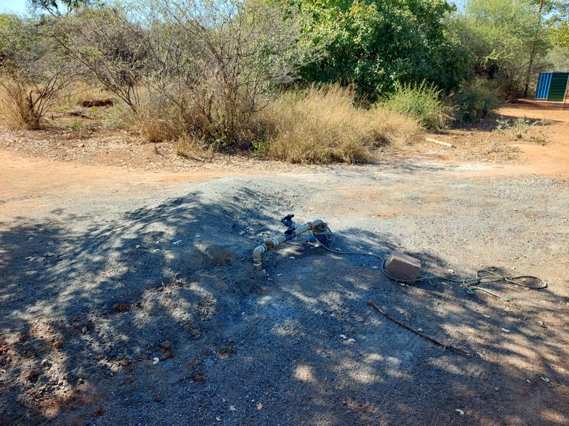 Outdoor borehole pump and water infrastructure located on the property grounds.