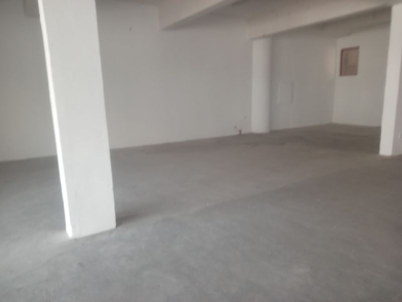 An open-plan retail space featuring unfinished concrete flooring and structural support columns, offering a blank canvas for custom commercial fit-out.