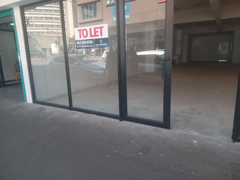 Vacant retail storefront featuring large glass display windows, modern black aluminum framing, and an open-plan interior layout suitable for various commercial uses.