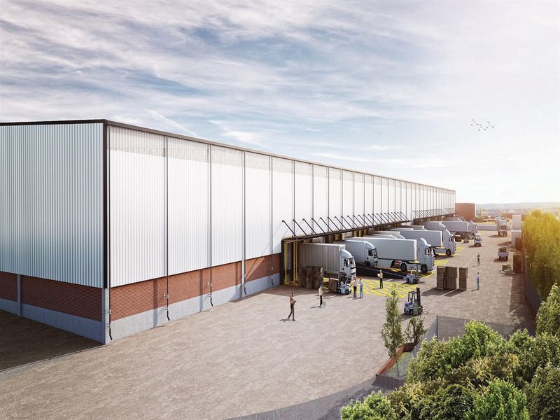 A wide-angle view of a large commercial warehouse facility featuring multiple loading docks, metal cladding, and a spacious concrete yard for logistics operations.