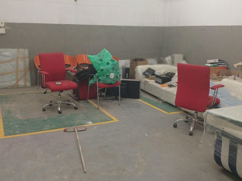 Industrial utility space featuring concrete flooring with painted safety markings, suitable for storage or workshop use.