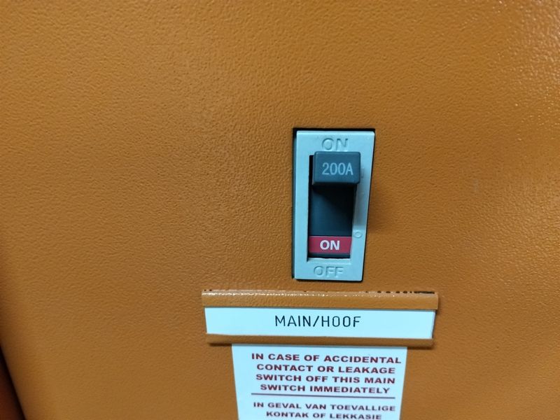 Close-up view of a 200A main electrical circuit breaker switch mounted on an industrial distribution board.