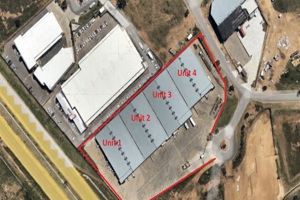 Aerial view of an industrial property complex featuring four distinct warehouse units with associated parking and access infrastructure.
