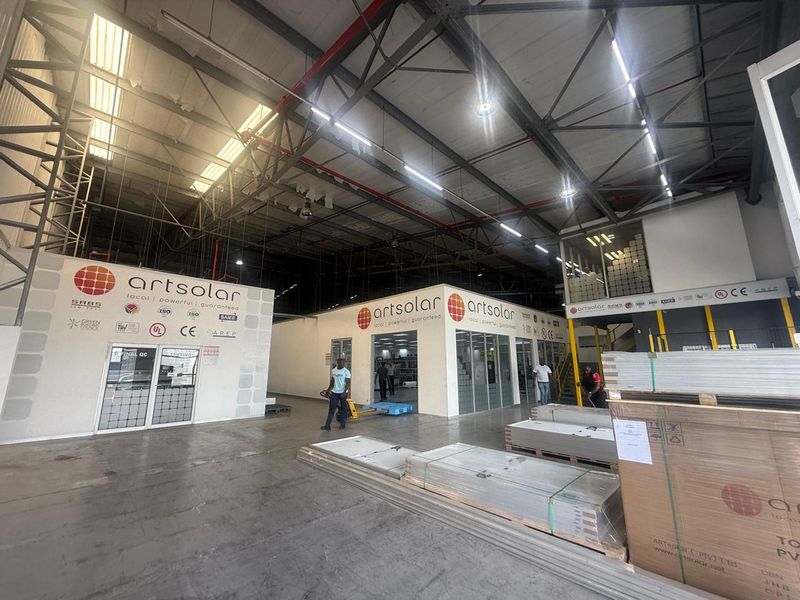 Spacious industrial warehouse facility featuring high ceilings, exposed steel trusses, integrated office enclosures, and polished concrete flooring suitable for manufacturing or logistics operations.