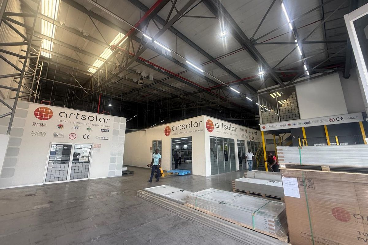 Spacious industrial warehouse facility featuring high ceilings, exposed steel trusses, integrated office enclosures, and polished concrete flooring suitable for manufacturing or logistics operations.