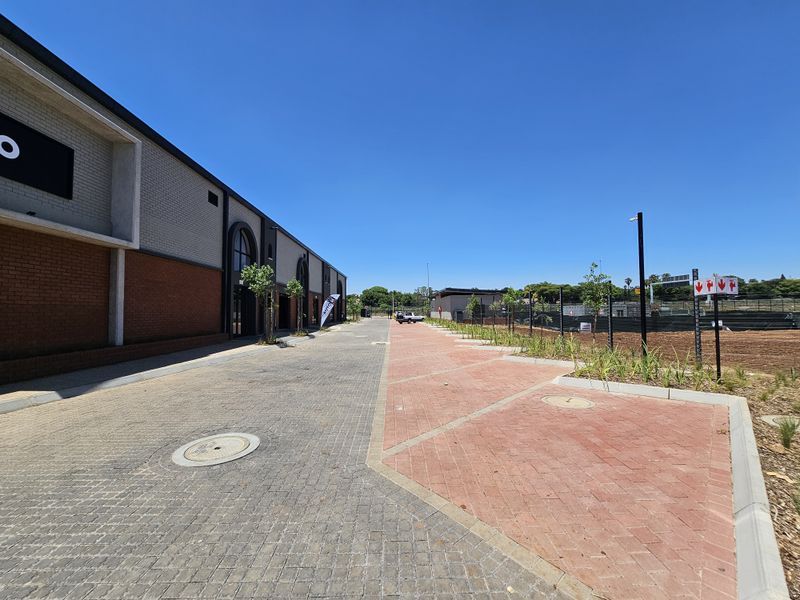Exterior view of a retail property featuring paved parking areas, brick facade detailing, and modern commercial building architecture.