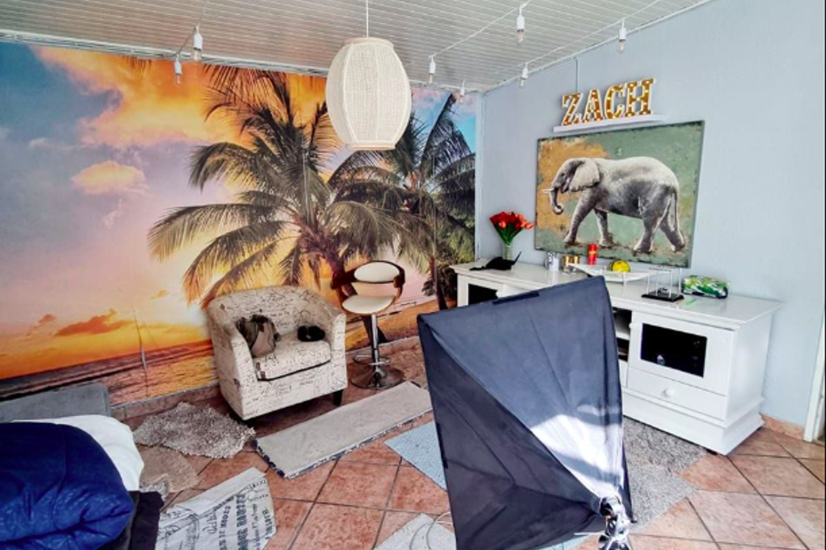 A living area featuring tiled flooring and a tongue and groove ceiling, currently utilized as a studio space.