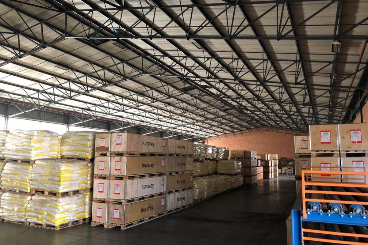 Spacious industrial warehouse featuring high-clearance exposed steel roof trusses, durable concrete flooring, and ample storage capacity for large-scale operations.