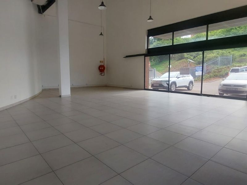 Spacious open-plan retail unit featuring large glass frontage, tiled flooring, and high ceilings, offering excellent visibility and natural light for a commercial business.