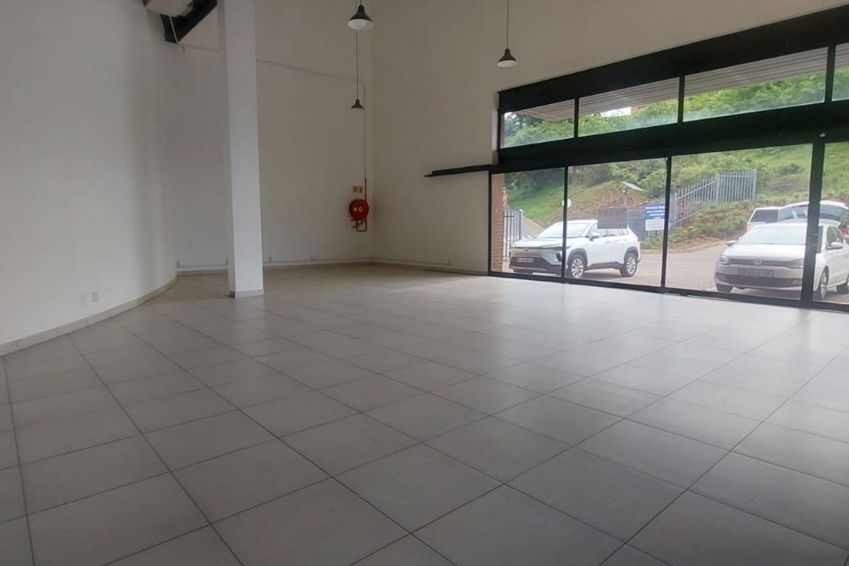 Spacious open-plan retail unit featuring large glass frontage, tiled flooring, and high ceilings, offering excellent visibility and natural light for a commercial business.