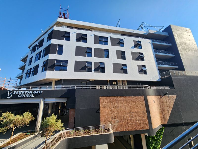 A modern multi-story office building facade featuring contemporary architectural design, clean lines, and integrated balcony structures.