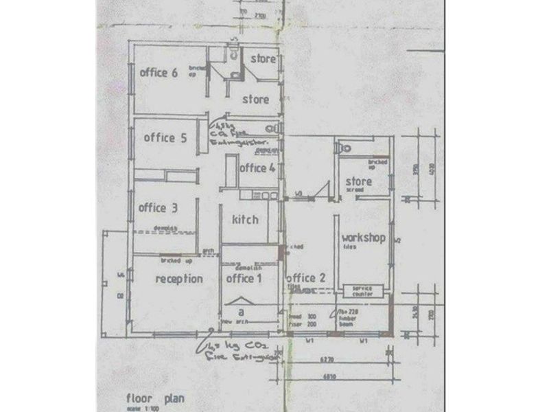 A floor plan diagram illustrating the layout of the retail property, including multiple offices, storage areas, a kitchen, and a workshop space.