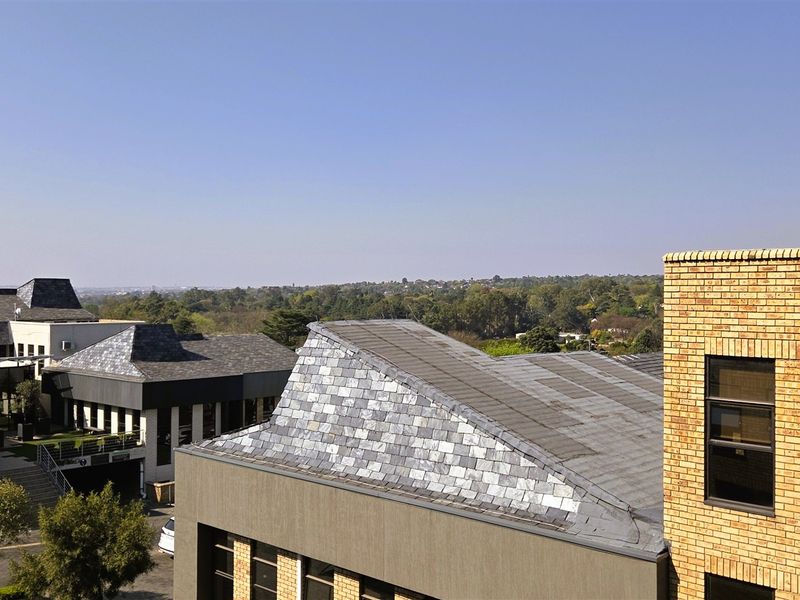 An elevated view overlooking the office park complex, showcasing modern architectural roof designs and face brick exterior finishes.