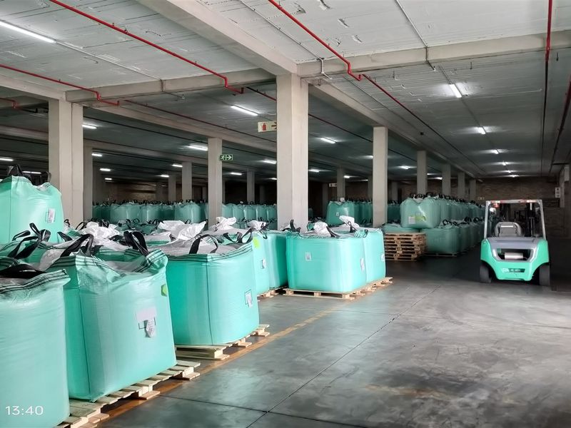 Spacious industrial warehouse facility featuring high ceilings with exposed fire sprinkler systems, concrete columns, and polished concrete flooring, suitable for large-scale storage operations.