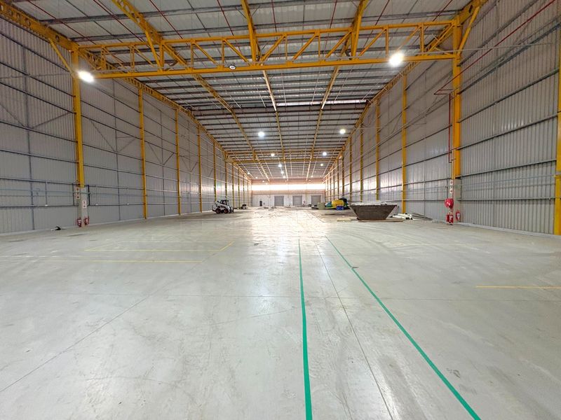 Spacious industrial warehouse featuring a high-clearance steel portal frame, polished concrete flooring, and integrated fire suppression systems.