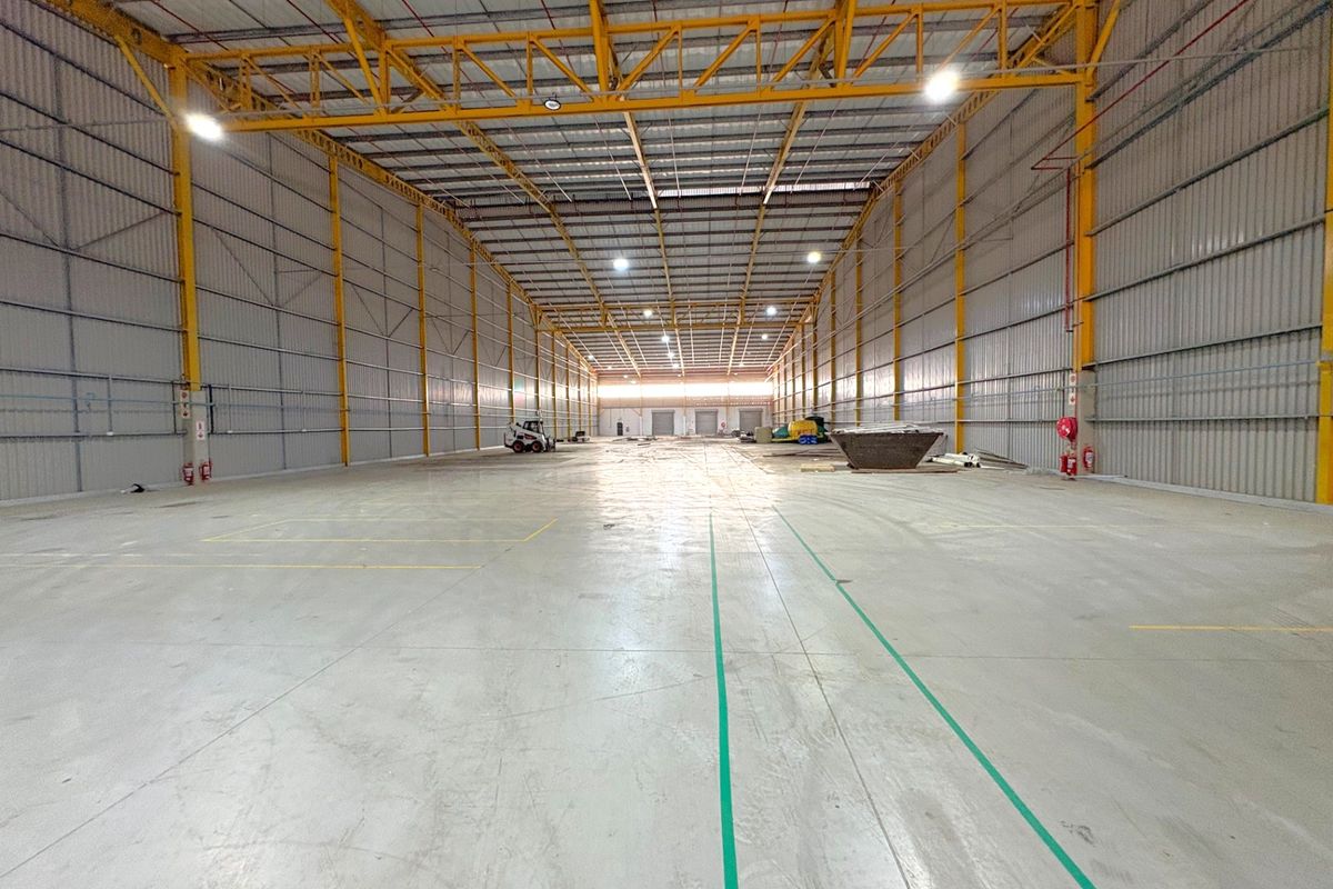 Spacious industrial warehouse featuring a high-clearance steel portal frame, polished concrete flooring, and integrated fire suppression systems.
