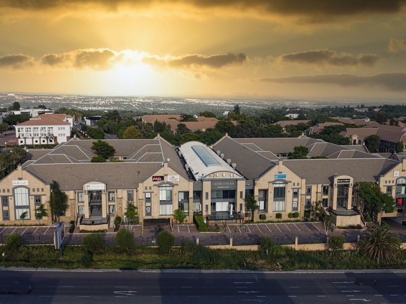 Aerial view of the Silver Stream business park complex, featuring multiple office buildings with tiled roofs, central skylight, and dedicated parking facilities.