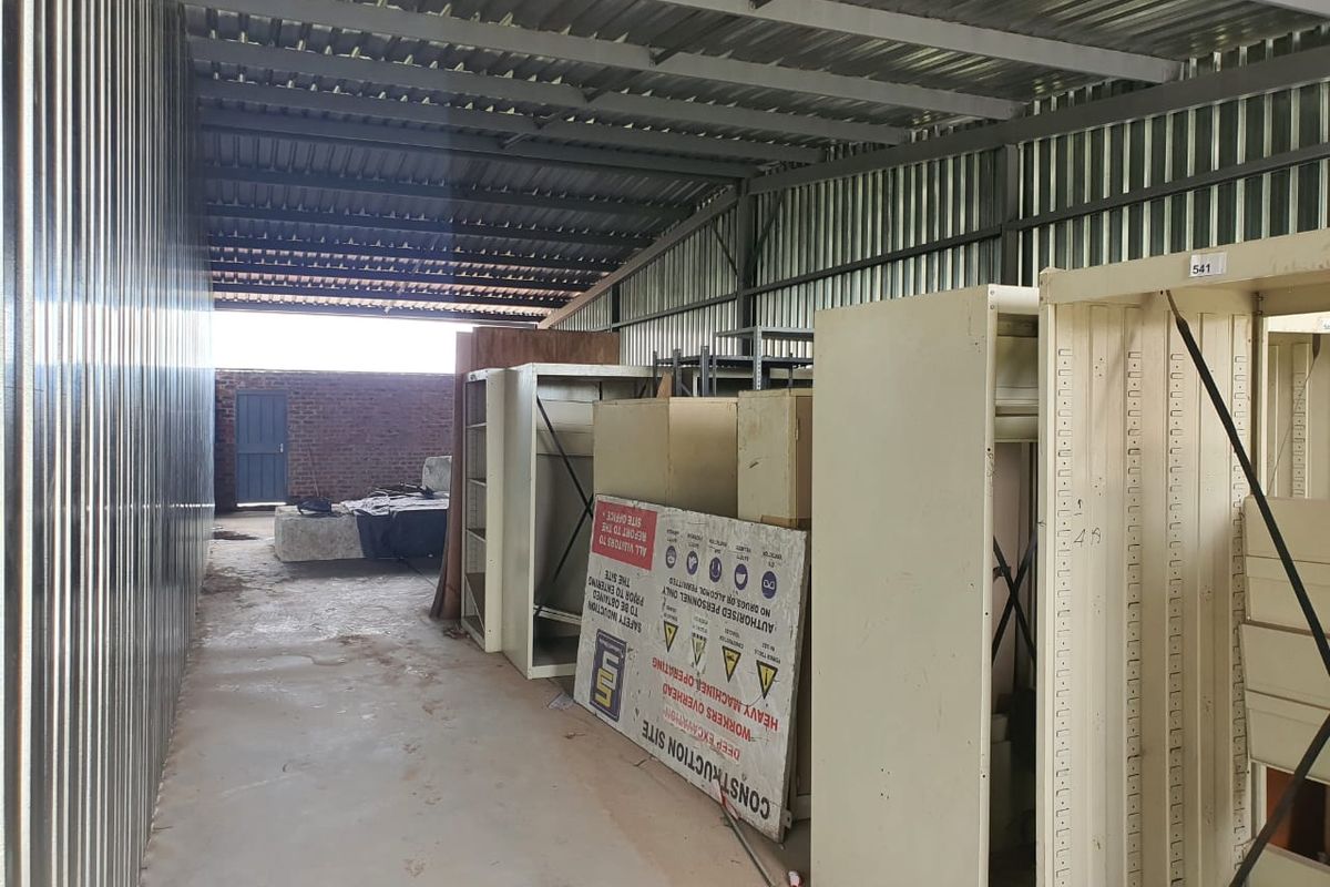 Industrial storage or utility space featuring corrugated metal walls and roofing with an open-plan layout.