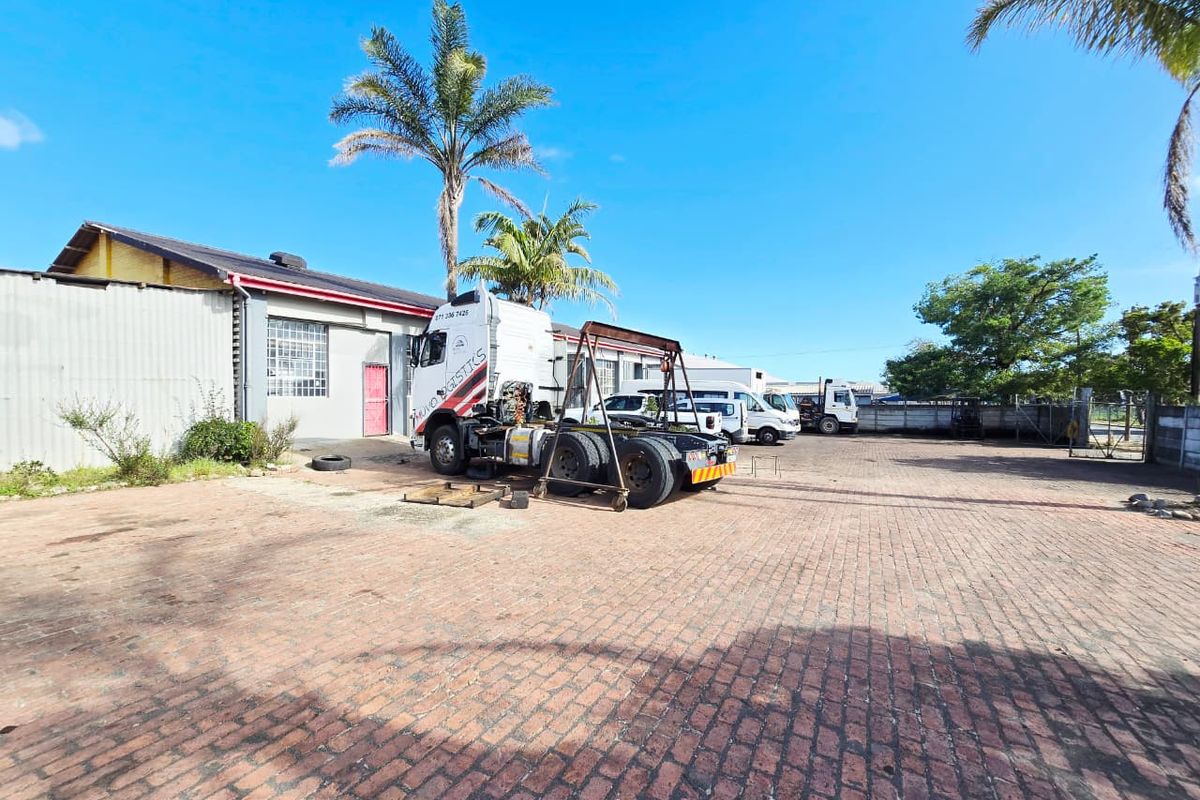 Spacious industrial yard area featuring paved surfacing and access to a warehouse facility, suitable for logistics or storage operations.
