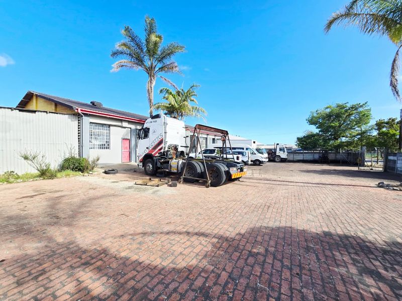 Spacious industrial yard area featuring paved surfacing and access to a warehouse facility, suitable for logistics or storage operations.