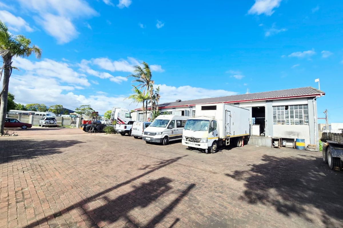 Industrial property featuring a large paved yard area with multiple loading bays and warehouse access points.
