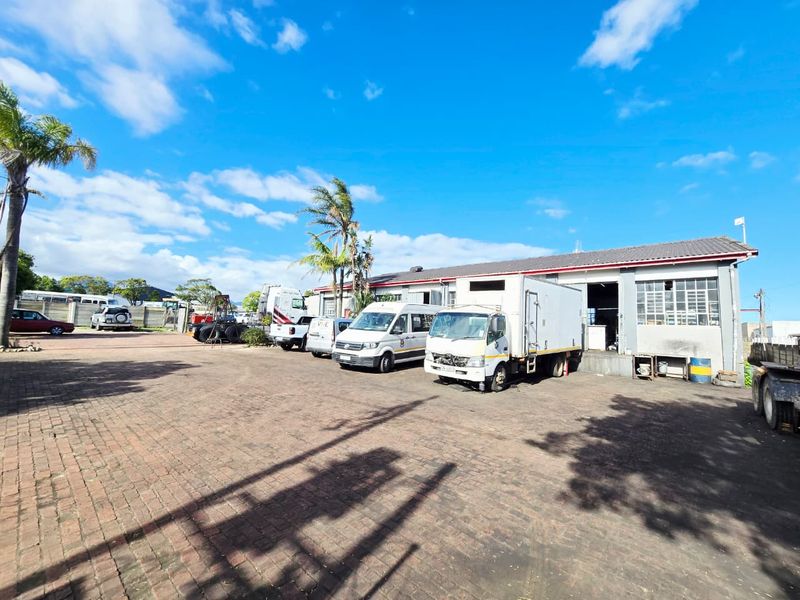 Industrial property featuring a large paved yard area with multiple loading bays and warehouse access points.