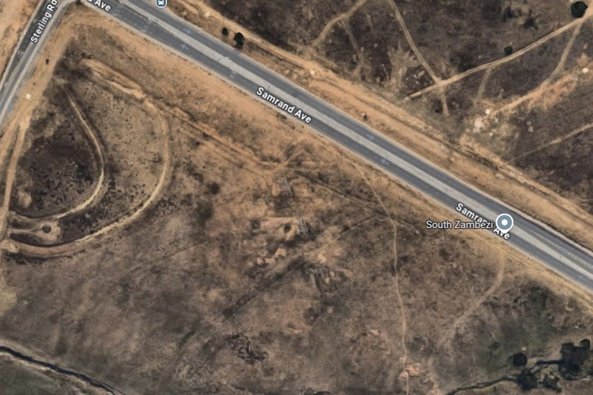 Aerial view of a vacant commercial land parcel situated adjacent to Samrand Avenue, offering significant development potential and road access.