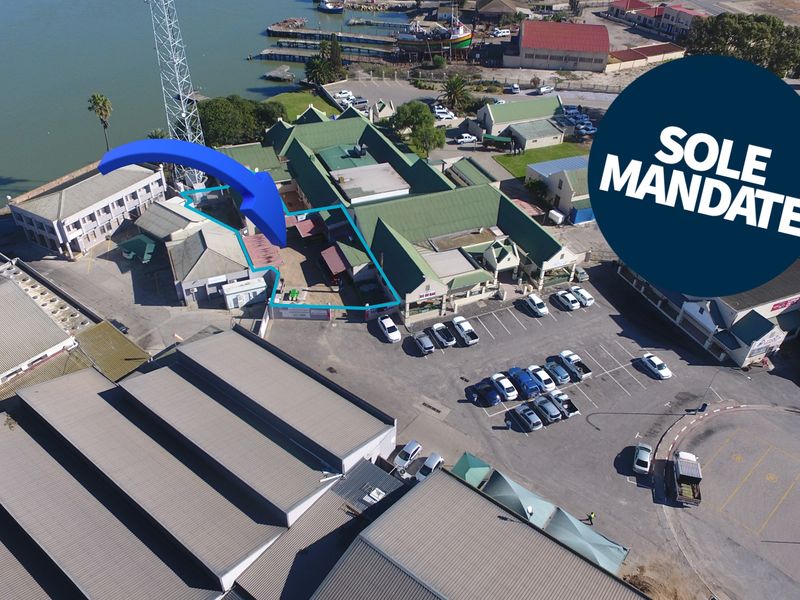 Aerial view of the restaurant property, highlighting the building structure, surrounding parking facilities, and proximity to the waterfront.