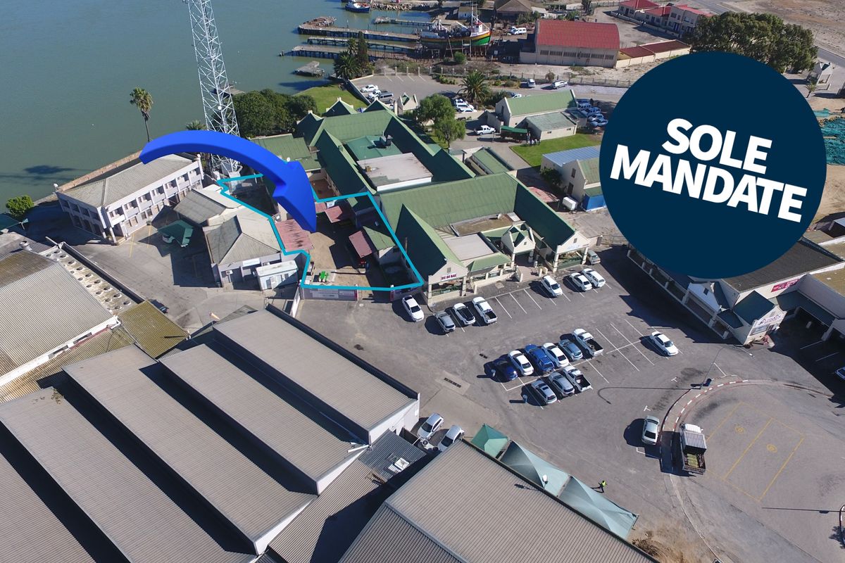 Aerial view of the restaurant property, highlighting the building structure, surrounding parking facilities, and proximity to the waterfront.