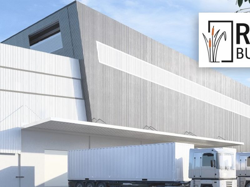 Modern industrial warehouse facility featuring corrugated metal cladding and a functional loading canopy, situated within the Rietvlei Business Park.