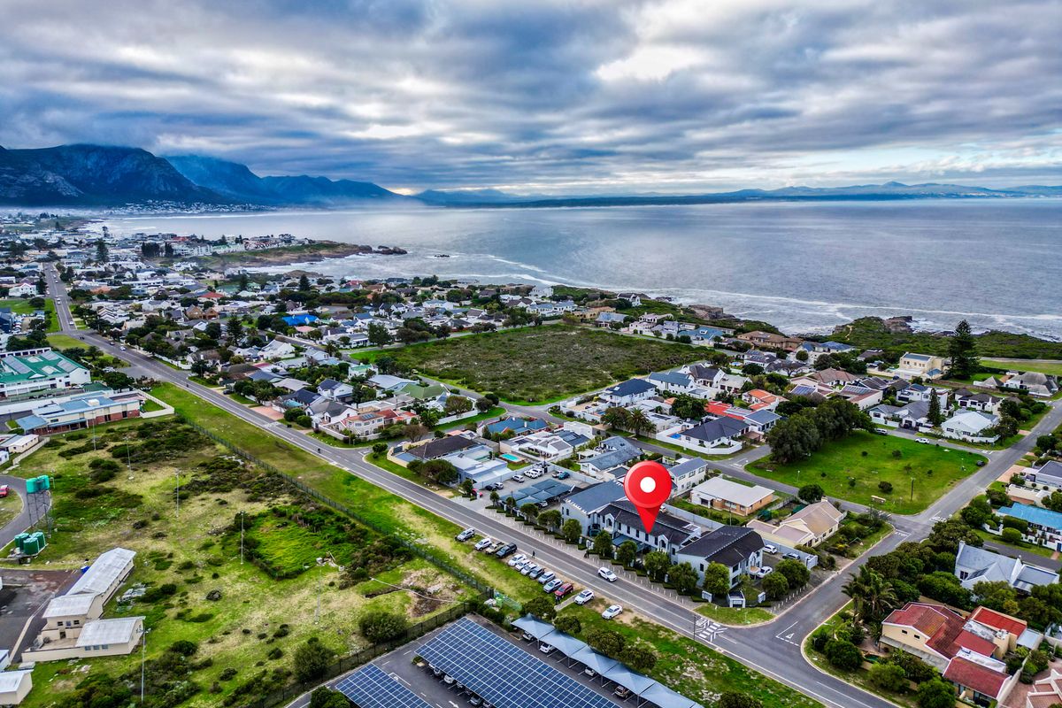 Aerial view of the commercial property location, highlighting proximity to the coastline, surrounding infrastructure, and integrated solar energy facilities.