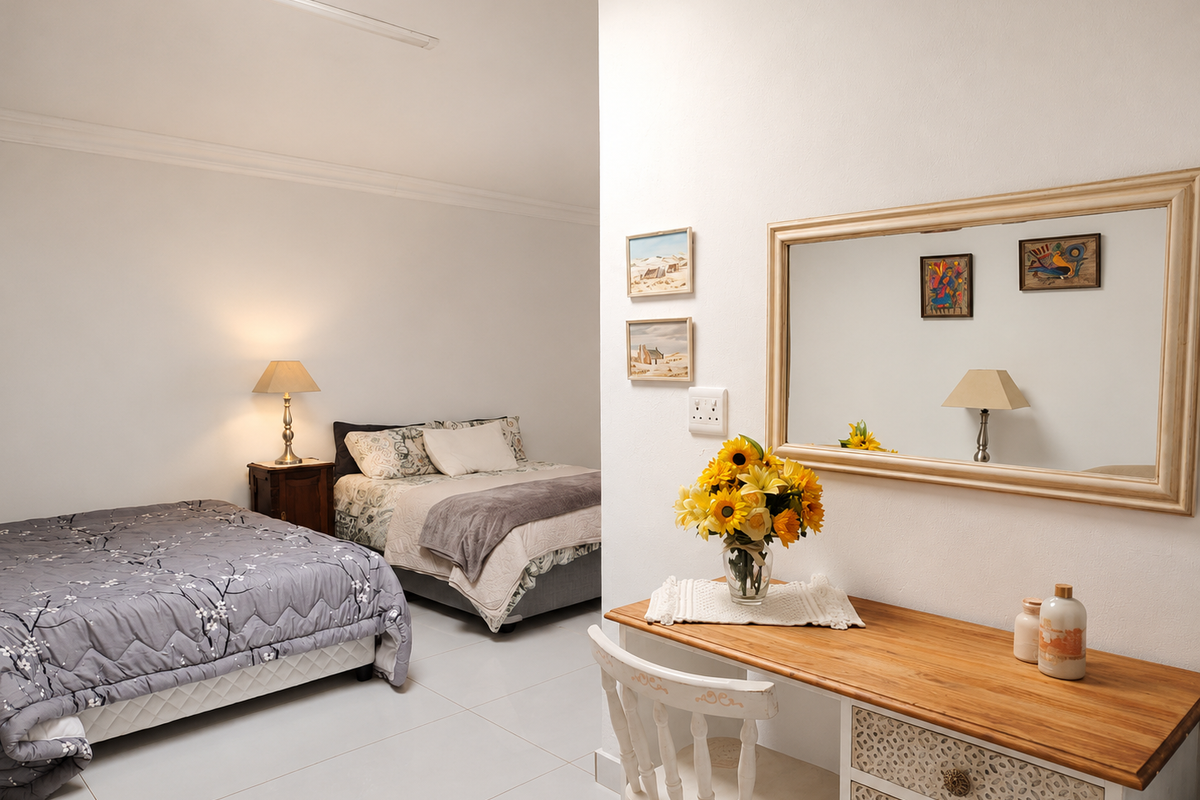 A spacious bedroom featuring neutral tiled flooring, clean white walls, and decorative cove cornicing, providing a bright and well-maintained living environment.