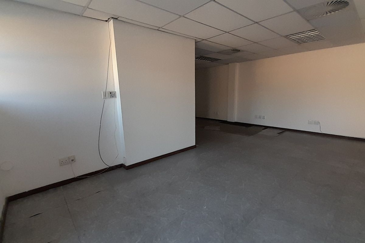 An empty, open-plan office space featuring a suspended ceiling, recessed air conditioning, and neutral vinyl flooring, ready for custom fit-out.