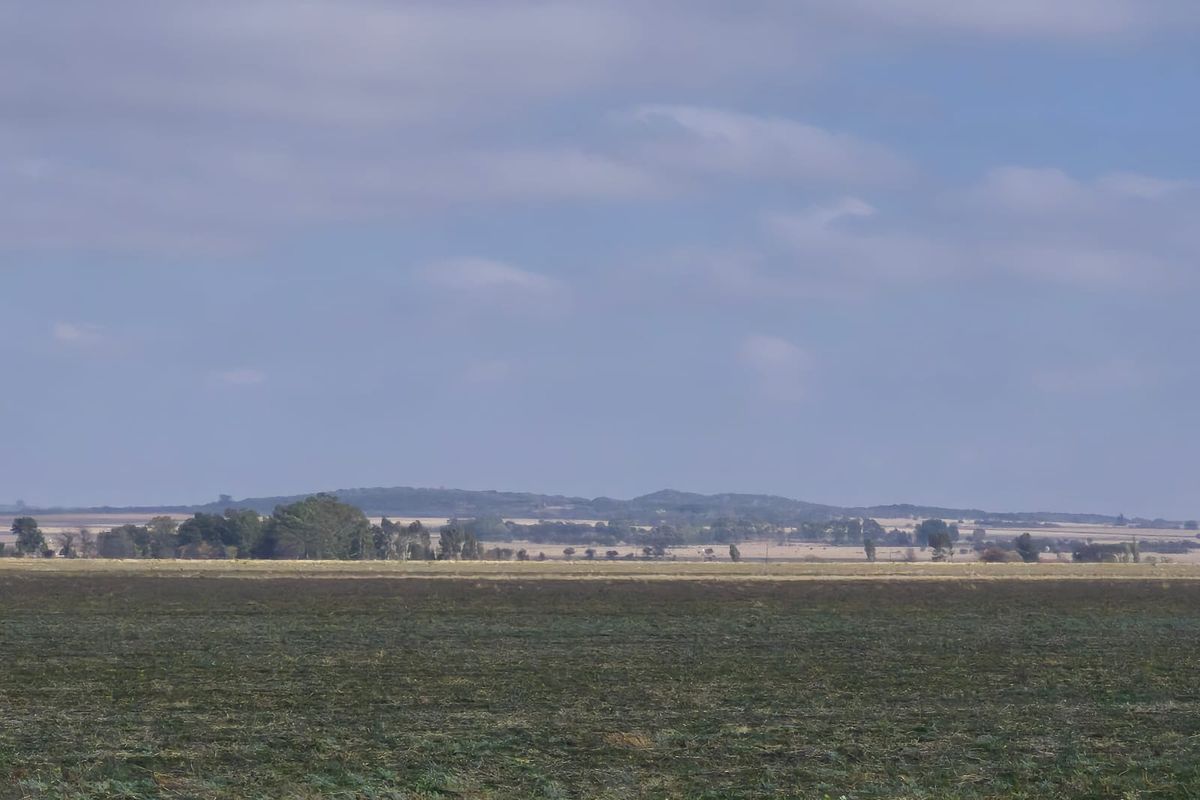 A wide-angle view of the expansive rural landscape and open fields surrounding the property.