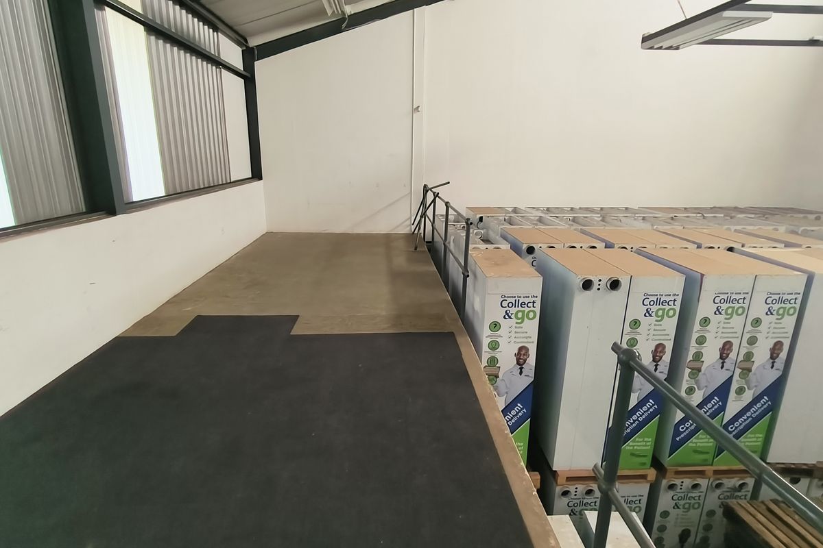Industrial utility space featuring concrete flooring, metal structural elements, and a raised platform area currently utilized for storage.