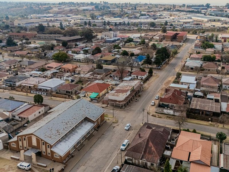 An aerial view of the surrounding urban neighborhood and street layout, showcasing the property's location within the local community.