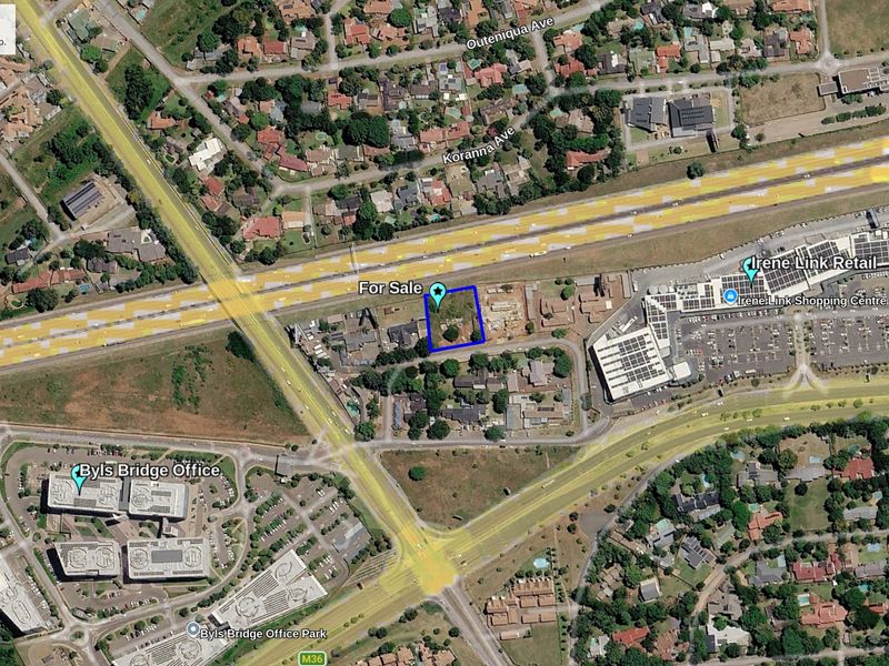 Aerial view of a vacant commercial land parcel situated in a prime location near major retail centers and office parks.