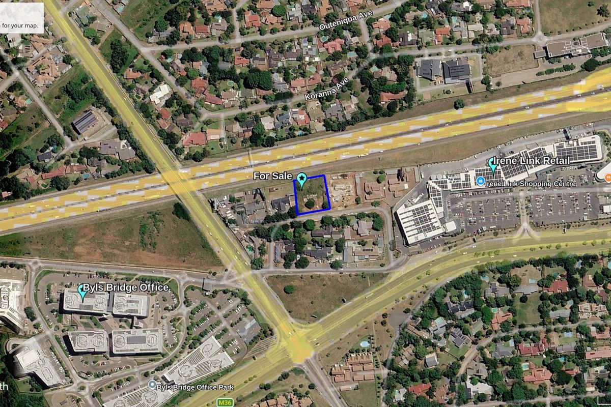 Aerial view of a vacant commercial land parcel situated in a prime location near major retail centers and office parks.