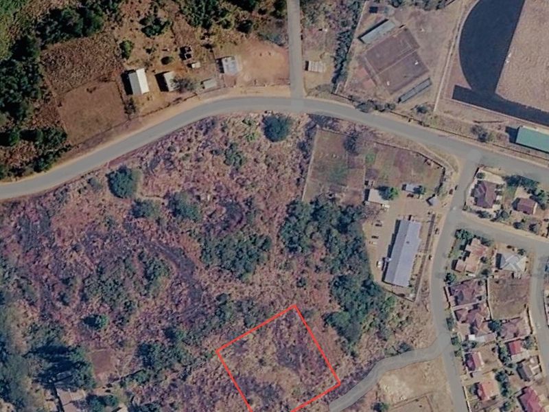 Aerial view of a vacant commercial land plot with surrounding road access and established neighborhood infrastructure.