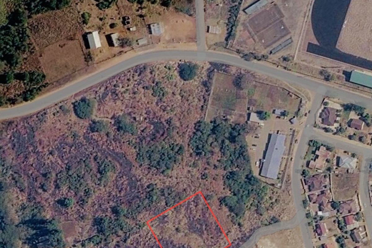 Aerial view of a vacant commercial land plot with surrounding road access and established neighborhood infrastructure.