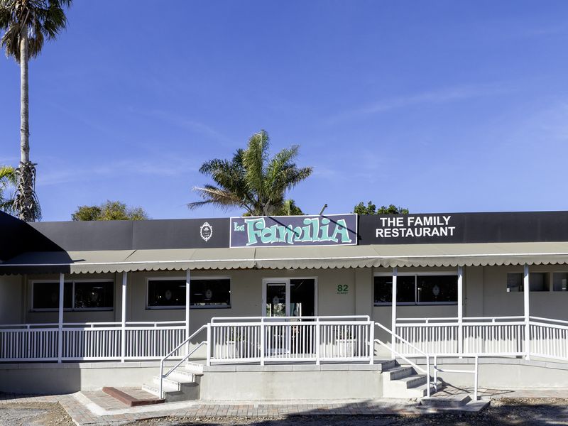 Front exterior view of the restaurant featuring a covered entrance, accessibility ramp, and prominent signage.